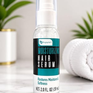 May include: A clear plastic bottle of b-pure moisturising hair serum with a white pump dispenser and a clear cap. The label features a teal and black design with the text "MOISTURISING HAIR SERUM" and "Restores Moisture & Softness" with 2.0 FL. OZ (59 ml).