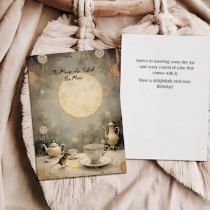 May include: A greeting card with the text "The Mouse who Tasted the Moon" and a watercolor illustration of a mouse, teacups, and a teapot. The card on the right has text wishing a happy birthday.