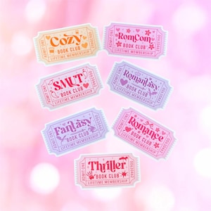 May include: Seven rectangular stickers shaped like admission tickets, each featuring a unique book club theme. The text includes Cozy, RomCom, Smut, Romantasy, Fantasy, Romance, and Thriller, all labeled as Lifetime Membership with Admit One.