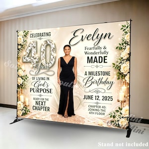 May include: A large rectangular backdrop banner featuring a cream and gold background with white floral arrangements on the sides. It displays the text Celebrating 40 Years, Evelyn, Fearfully & Wonderfully MADE, A MILESTONE Birthday, JUNE 12, 2025.