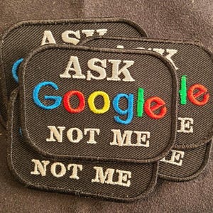 May include: A set of rectangular black embroidered patches with rounded corners. Each patch features the white text ASK on the top line, the word Google in blue, red, yellow, and green letters in the middle, and the white text NOT ME below.