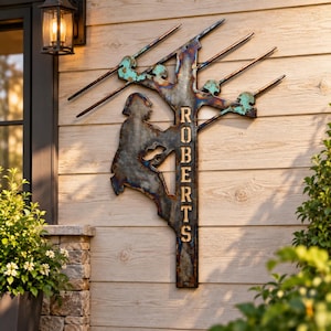 May include: A metal wall sign featuring a silhouette of a utility worker climbing a pole. The sign has a weathered, multi-colored finish with blue and copper tones. The name ROBERTS is vertically cut out in capital letters along the pole.