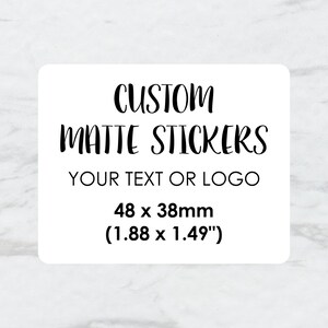 May include: White rectangular sticker with black text that reads "CUSTOM MATTE STICKERS YOUR TEXT OR LOGO 48 x 38mm (1.88 x 1.49")"