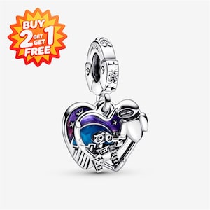 May include: A silver heart-shaped charm featuring a detailed depiction of the robot Wall-E and Eve against a blue and purple enamel night sky background with stars. The charm includes a bail engraved with the word Pandora and small clear stones.