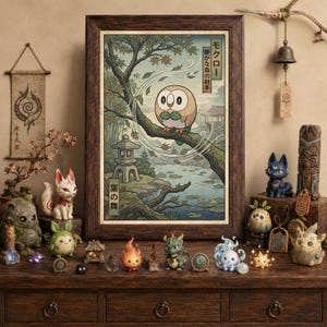 May include: A framed art print featuring a round, brown and white owl character perched on a tree branch in a forest setting with a stone lantern and pond. The print includes Japanese text and is surrounded by various small fantasy creature figurines.