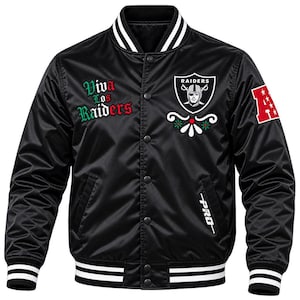 May include: A black satin varsity jacket featuring a snap-button front, striped ribbed collar, cuffs, and hem. The chest displays the Raiders logo, a floral graphic, and the text "Viva Los Raiders" in green and red. A red patch with a white "A" is on the sleeve.
