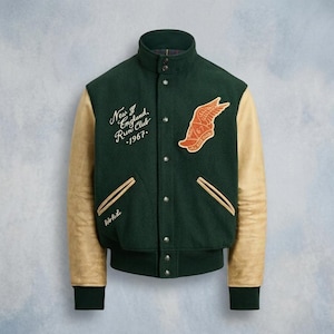 May include: A dark green varsity jacket with tan leather sleeves, a high collar, and snap-button closure. The chest features an embroidered orange winged emblem with the number 67 and white script text reading New England Run Club 1967.