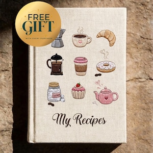 May include: A beige hardback recipe book titled My Recipes with embroidered illustrations of a moka pot, coffee cup, croissant, French press, coffee cup, doughnut, sugar jar, cupcake, and teapot, plus a gold circular sticker reading FREE GIFT.