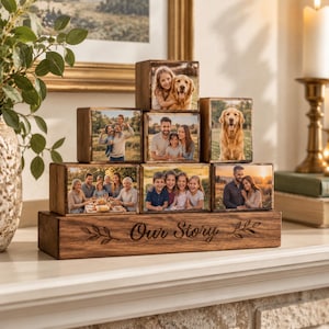 May include: A wooden display stand featuring the engraved text Our Story with decorative leaf accents. The stand holds seven stacked wooden blocks, each displaying a different colour photograph of family members and a golden retriever dog.
