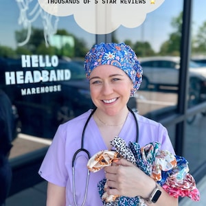 May include: A woman wearing a purple scrub top and a colorful patterned surgical cap holds a variety of colorful headbands. The text "HELLO HEADBAND WAREHOUSE" is visible on a sign behind her. The text "hello headband" is written in a retro font at the bottom of the image.