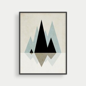 May include: Abstract geometric art print featuring black and blue triangles on a beige background. The triangles are arranged to resemble mountains reflecting in water.