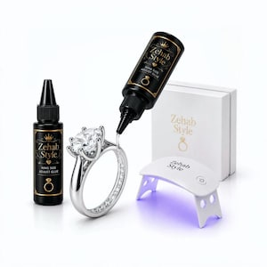 May include: A ring size adjustment kit featuring two black bottles labeled Zehab Style Ring Size Adjust Glue, a silver ring with a large clear stone, a white box with the Zehab Style logo, and a small white portable UV light curing lamp.
