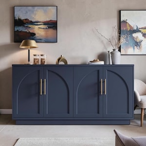 May include: A dark blue four-door sideboard featuring arched recessed panels on each door and vertical gold-toned metal bar handles. The cabinet has a flat rectangular top surface and a solid base, providing a clean and structured storage unit.