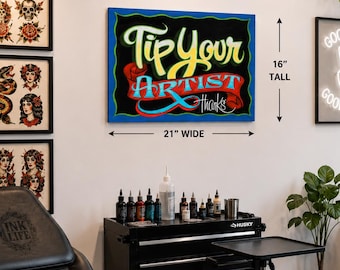 May include: A rectangular wall sign featuring the text Tip Your Artist Thanks in yellow and red script on a black background with a blue border. The sign measures 21 inches wide by 16 inches tall, displayed in a tattoo studio setting.