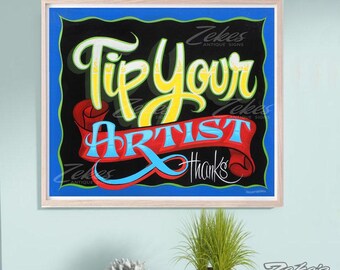 May include: A rectangular sign with a light wood frame featuring a black background and a blue border. The text reads Tip Your Artist in yellow and light blue script, set against a red ribbon graphic with the word thanks in white script.