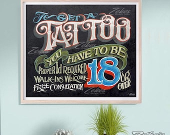 May include: A rectangular framed sign with a dark textured background featuring white, red, and blue lettering that reads: To get a tattoo you have to be 18 or over. Additional text includes Proper ID Required, Walk-ins Welcome, and Free Consultation.