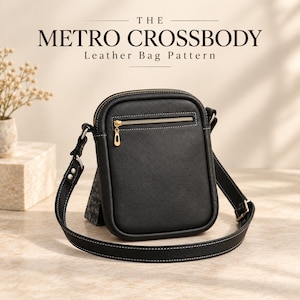 May include: A black leather crossbody bag with a gold zipper, an adjustable strap, and white contrast stitching. The text THE METRO CROSSBODY Leather Bag Pattern is displayed above the bag, which features a front pocket and a structured design.