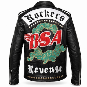 May include: A black leather jacket featuring a large back patch with the red text BSA, a green laurel wreath design, and white panels with the black text Rockers and Revenge. The jacket includes silver metal studs along the top and bottom edges.