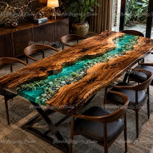 May include: A rectangular dining table featuring a live-edge wood slab with a central river design made of translucent turquoise resin filled with smooth river stones, supported by a black metal X-frame base and six matching wooden chairs.