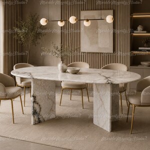 Ovale eettafel van wit marmer – sculpturale plaatvoet, luxe meubelstuk van natuursteen.
