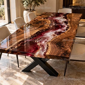 May include: A rectangular dining table featuring a natural wood slab with a live edge and a central river inlay of glossy, deep burgundy and white resin. The table is supported by a black metal X-shaped base and surrounded by six upholstered chairs.