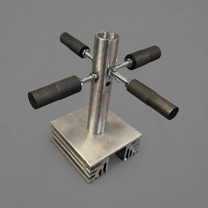 May include: A metallic industrial component featuring a central threaded cylinder mounted on a square, finned aluminum base. Four horizontal rods extend from the center, each tipped with a dark gray cylindrical sleeve secured by metal hardware.