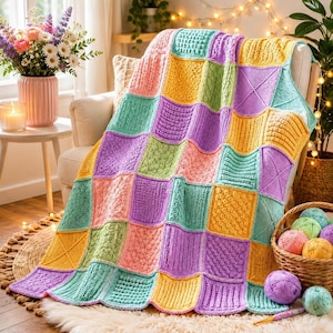 May include: A handmade patchwork blanket featuring a grid of square knit panels in pastel shades of yellow, lavender, mint green, and peach. Each square displays a unique textured stitch pattern, including cables, bobbles, and ribbed designs.