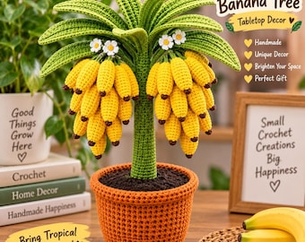 May include: A handmade crochet banana tree tabletop decoration featuring a textured green trunk, large green leaves, and two clusters of yellow bananas with small white flowers. The tree is potted in a round orange crochet base.
