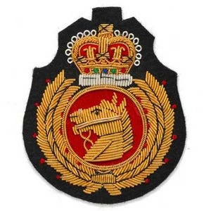 May include: A black embroidered patch featuring a gold horse head profile centered within a red circular field, surrounded by a gold laurel wreath. Above the circle is a detailed gold crown with red and blue accents, all on a black felt base.