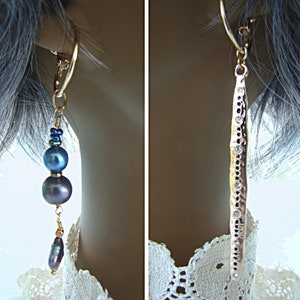 May include: A pair of earrings, one with a hammered gold bar and clear stones, and the other with a gold hoop and three dark blue pearls.