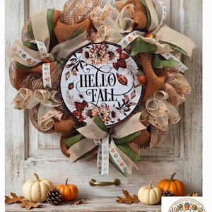 May include: A decorative wreath featuring brown and cream mesh, green and tan ribbons with small pumpkin prints, and a central circular sign with the text HELLO FALL surrounded by illustrations of autumn leaves and flowers in warm tones.