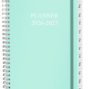 May include: A mint green spiral-bound planner with a vertical elastic closure band. The cover features the white text PLANNER 2026-2027. The right edge includes white monthly tabs labeled from Jul through Jun, organized in a vertical sequence.