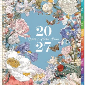May include: A 2027 weekly and monthly planner with a light blue cover featuring a detailed botanical illustration of various flowers, including peonies and irises, and a butterfly. The planner has a gold spiral binding and colored monthly tabs.