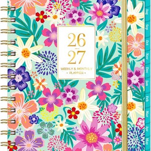 May include: A spiral-bound weekly and monthly planner featuring a vibrant floral pattern on a light mint green background. The cover displays the text 26-27 WEEKLY & MONTHLY PLANNER in gold lettering. It includes a gold elastic band and side tabs.
