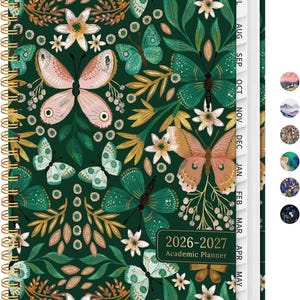 May include: A 2026-2027 academic planner with a dark green cover featuring a pattern of butterflies and white flowers. The planner has a gold spiral binding on the left side and white monthly tab dividers on the right edge. Six small circular color swatches are visible.