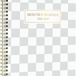 May include: A spiral-bound monthly planner with a white and light gray checkered pattern. A rectangular label in the center features a gold border and the text "MONTHLY PLANNER 2026-2027" in gold lettering. The binding consists of gold-colored metal wire.