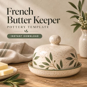 Könnte beinhalten: Ein Buttergefäß aus Keramik mit gesprenkelter cremefarbener Glasur und grünen Blattillustrationen. Das Set besteht aus einem gewölbten Deckel mit rundem Knauf und einem passenden Unterteller. Der Text lautet French Butter Keeper Pottery Template.