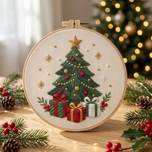 May include: A circular embroidery hoop featuring a stitched green Christmas tree topped with a gold star, decorated with red and gold ornaments. Three wrapped gift boxes sit at the base, surrounded by embroidered snowflakes and beads.