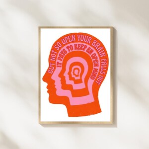 May include: A rectangular wall art print featuring a nested profile illustration of human heads in alternating orange and pink colors. The text reads: BUT NOT SO OPEN YOUR BRAIN FALLS OUT IT PAYS TO KEEP AN OPEN MIND, following the head shape.