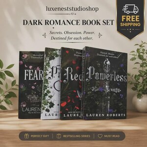 May include: A set of four books titled Dark Romance Book Set by Lauren Roberts, including Fear, Powerless, and others. The covers feature dark, botanical, and sword illustrations with white text. The set is displayed on a wooden surface.
