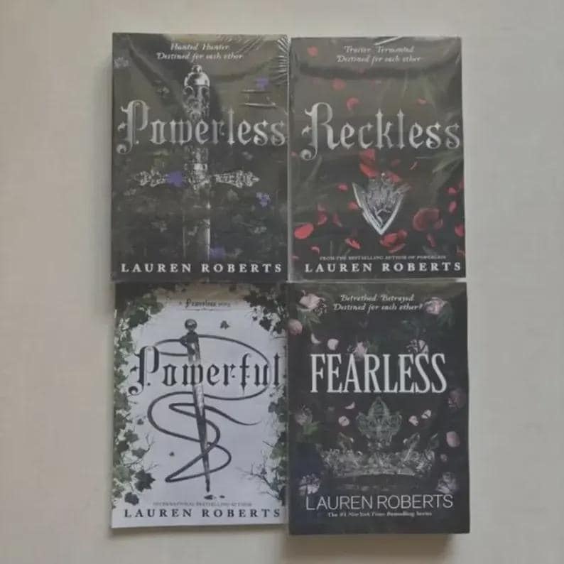 May include: A collection of four books by Lauren Roberts, including Powerless, Reckless, Powerful, and Fearless. The covers feature dark, intricate illustrations of swords, crowns, and floral motifs in black, white, and red, all wrapped in plastic.