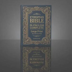 May include: A dark blue hardcover book titled Ethiopian Bible In English Complete Large Print Illustrated. The cover features an ornate gold-colored decorative border with intricate scrollwork patterns surrounding the centered text.