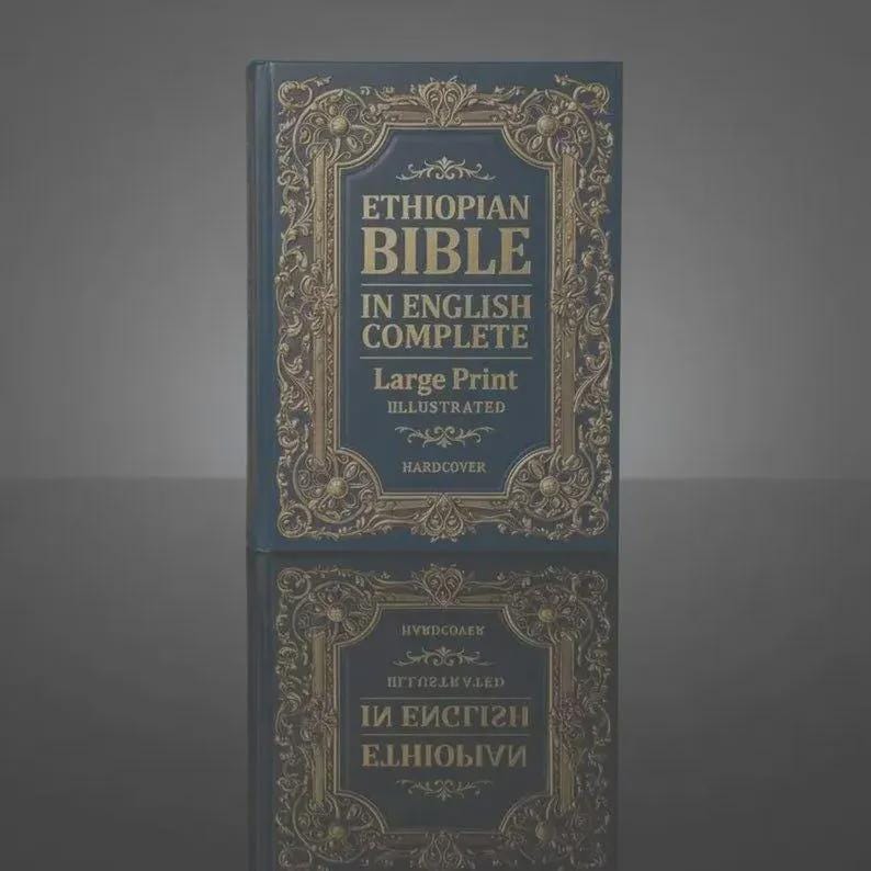 May include: A dark blue hardcover book titled Ethiopian Bible In English Complete Large Print Illustrated. The cover features an ornate gold-colored decorative border with intricate scrollwork patterns surrounding the centered text.