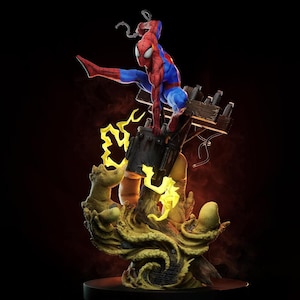 May include: A detailed figurine of a red and blue costumed character perched on a utility pole transformer. The base features sculpted yellow lightning effects and textured sand-like elements, creating a dynamic scene with a dark background.