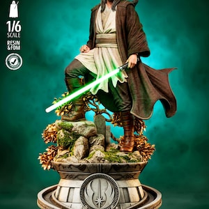 May include: A 1/6 scale resin and FDM statue of a bearded figure in a brown robe and tunic, holding a glowing green lightsaber. The figure stands on a rocky base with gold foliage, atop a circular pedestal featuring a Jedi Order symbol emblem.