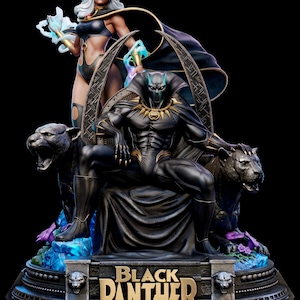 May include: A detailed collectible statue featuring Black Panther seated on a throne flanked by two black panthers, with Storm standing behind. The base displays the text Black Panther in gold lettering, with blue energy effects and purple flowers.