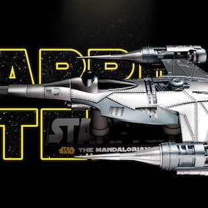 May include: A silver N-1 starfighter model featuring a pointed nose, two large cylindrical engines, and a cockpit canopy. The background displays the text "STAR WARS THE MANDALORIAN" and large yellow outlined letters. The model has visible panel lines.