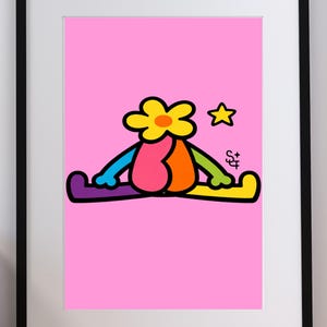 May include: A framed art print featuring a cartoon character with a yellow flower head, a pink and orange body, and rainbow-colored limbs sitting in a split position on a bright pink background. A small yellow star and the letters SF are visible.