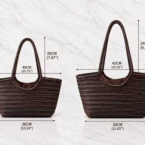 May include: Two dark brown woven tote bags with braided handles. The smaller bag measures 40 cm wide, 20 cm high, and 12 cm deep. The larger bag measures 43 cm wide, 23 cm high, and 12 cm deep, with a handle drop of 24 cm.