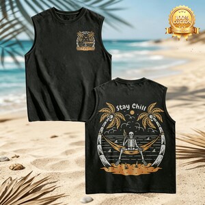 May include: A black sleeveless shirt featuring a small graphic on the chest and a large back print of a skeleton relaxing in a hammock between two palm trees, holding a bottle, with the text "Stay Chill" and a gold 100% cotton seal.